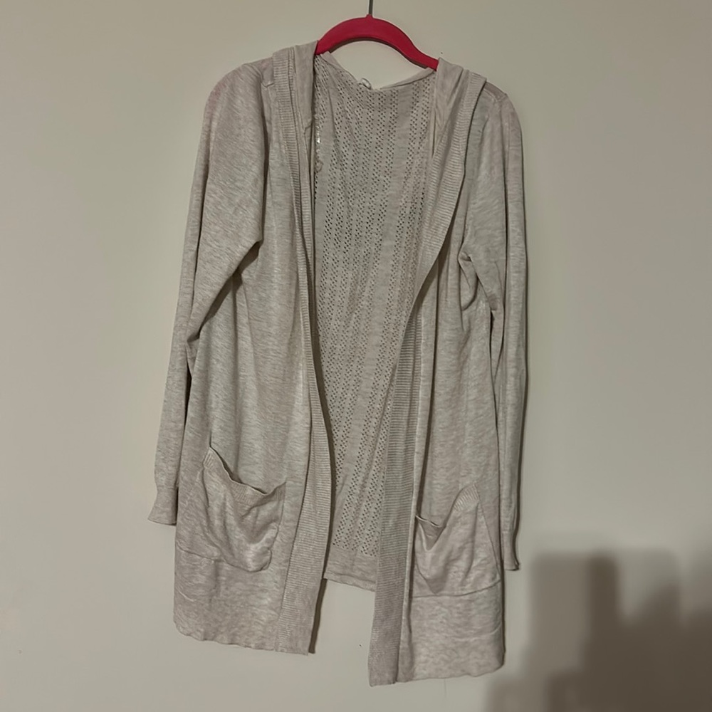 Light sweater with pockets and hood. Size is XL.